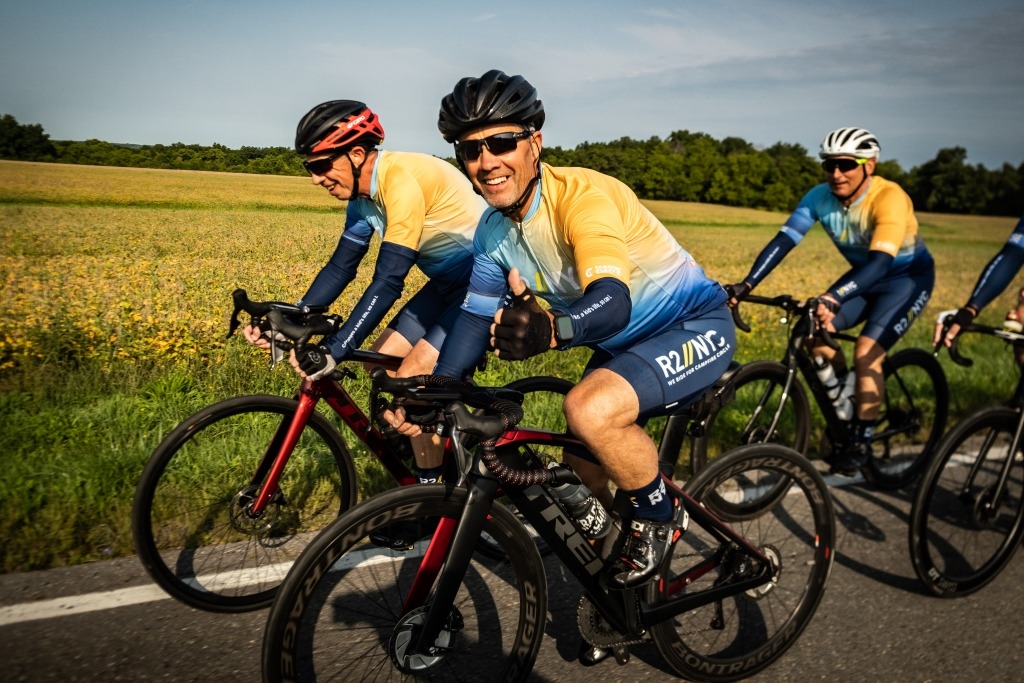 three cyclists biking outside together