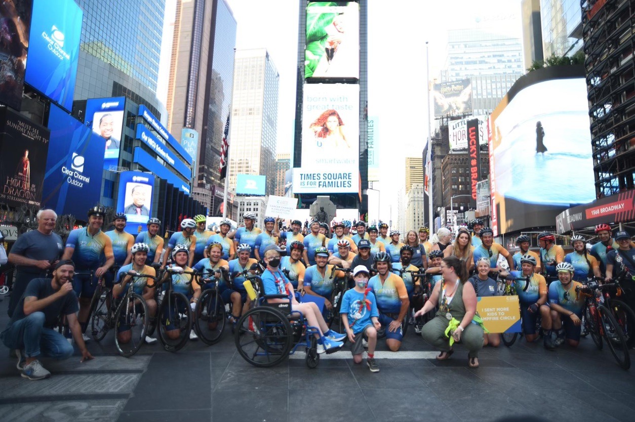 group of cyclists in Times Square posing for a group picture