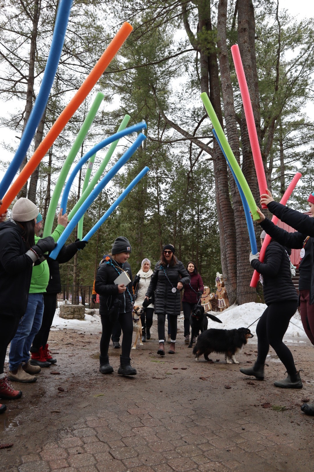 participants being greeted with a pool noodle tunnel