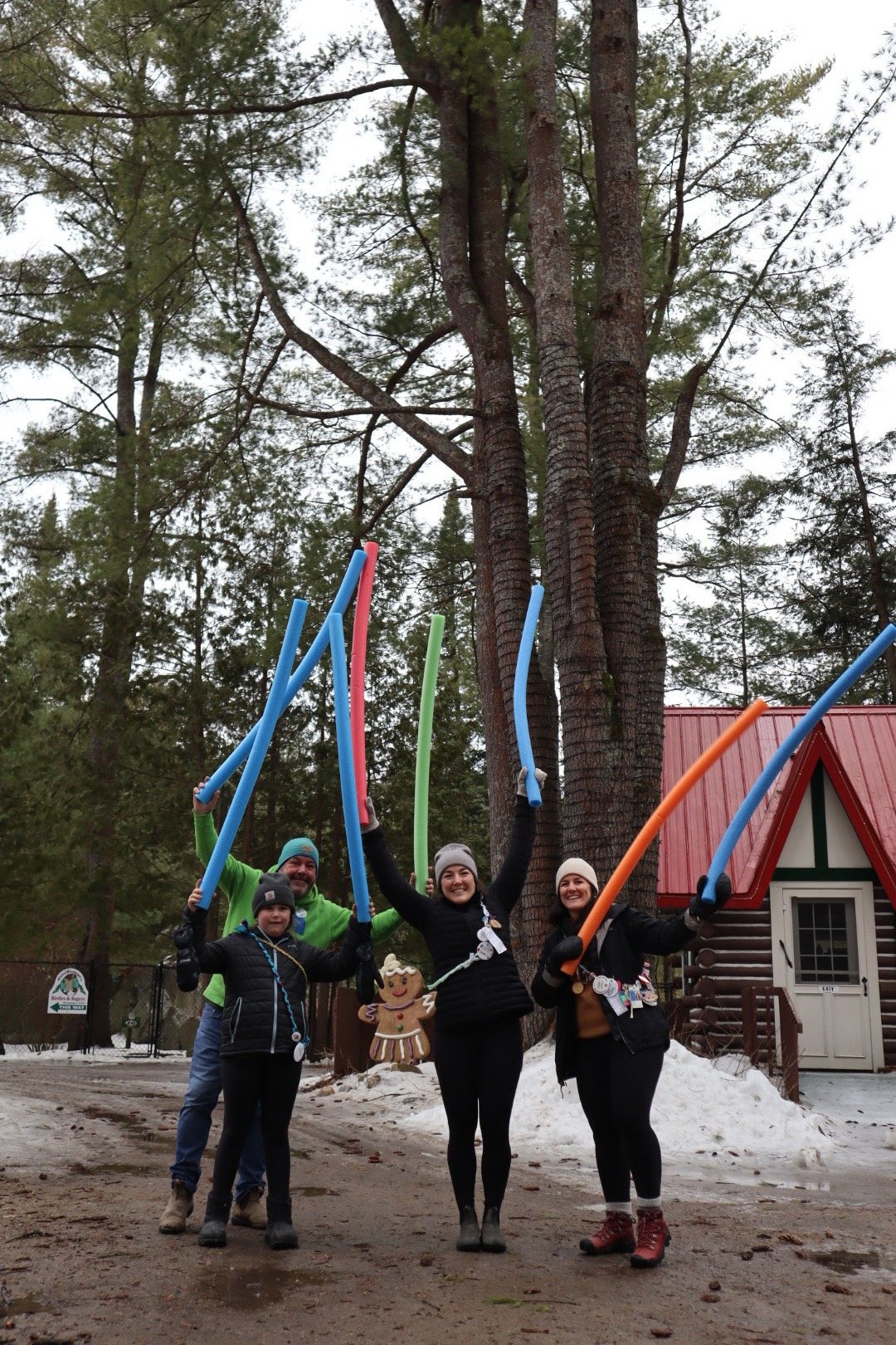 participants holding pool noodles in the air