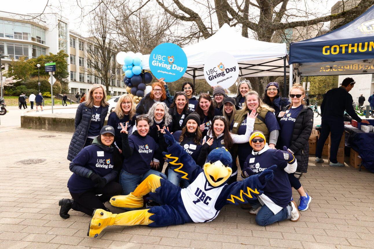 Group celebrating UBC Giving Day at an outdoor event with Thunder.