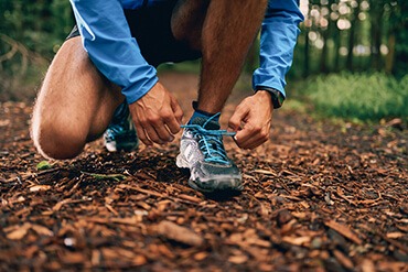 Lone runner tying shoe