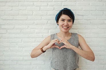 Woman making a heart sign with her hands